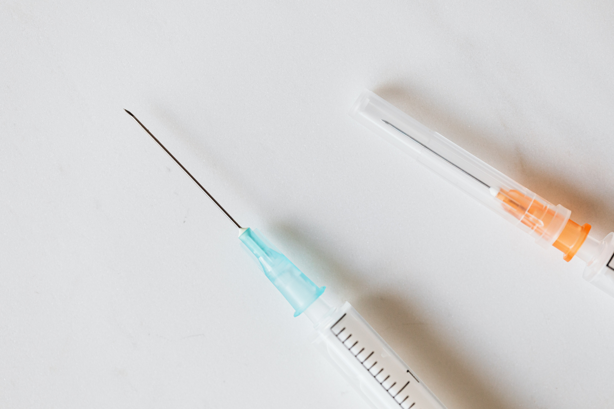 Syringes with needles on table in clinic